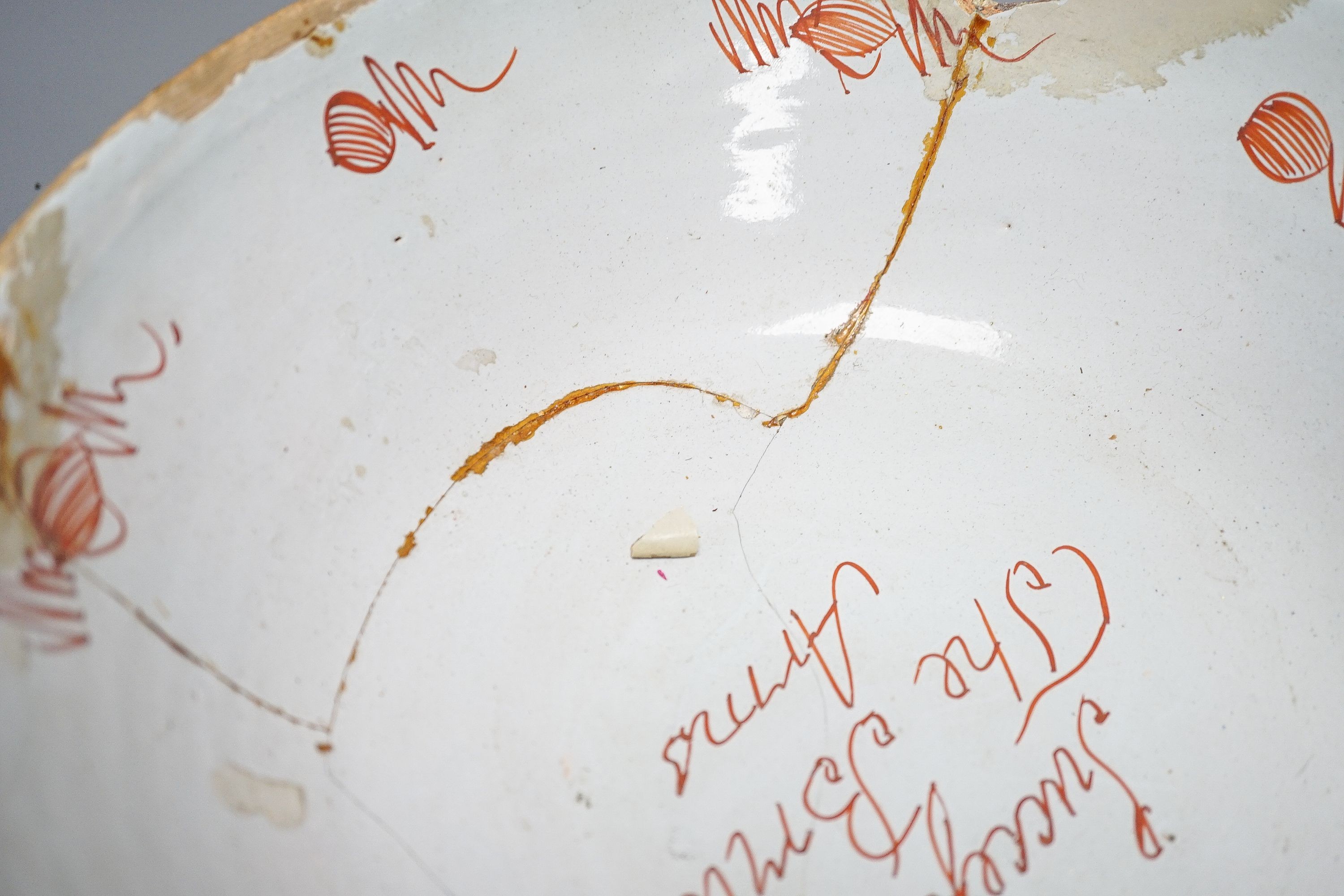 An 18th century English polychrome delftware bowl, interior inscribed 